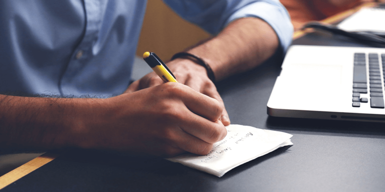 A man writing a list.