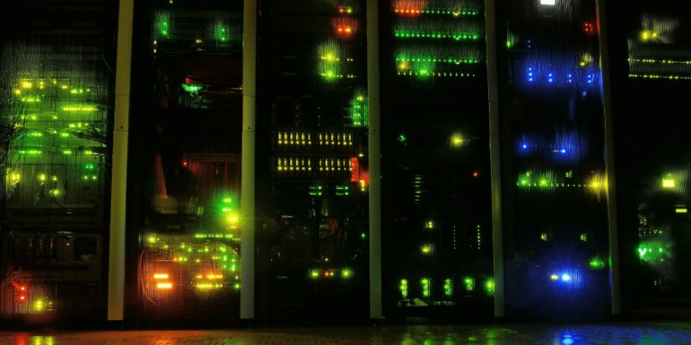 A line of servers in a dark room.