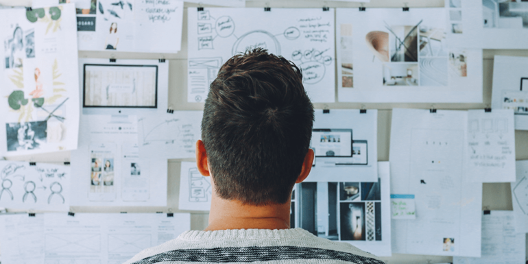 A man staring at an idea board.